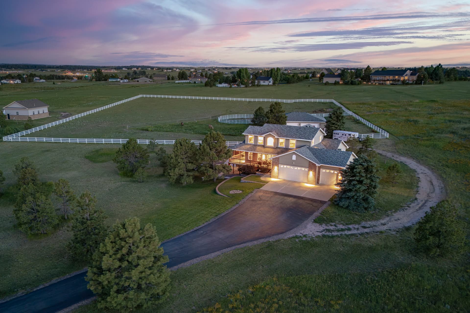 an aerial photo of a rural home at dusk